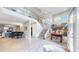 Open concept living room with hardwood floors, grand piano, dining table and unique chandelier at 463 Locust St, Denver, CO 80220