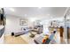 Open living area with hardwood floors, a cozy sectional, and a clear view to the kitchen at 463 Locust St, Denver, CO 80220