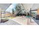 Spacious stone patio with an outdoor seating area, lush greenery, and mature trees at 463 Locust St, Denver, CO 80220