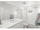 Bright bathroom featuring a large mirror, vanity with sink, toilet, and shower/tub combo at 11989 E Lake Cir, Greenwood Village, CO 80111