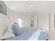 Bright bedroom featuring a bed with white comforter and patterned blue pillows plus a ceiling fan at 11989 E Lake Cir, Greenwood Village, CO 80111