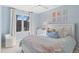 Bedroom featuring light blue walls, carpeted floor, a large window and a bed at 11989 E Lake Cir, Greenwood Village, CO 80111