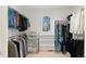 Walk-in closet featuring hanging clothes, shelving, and a window at 11989 E Lake Cir, Greenwood Village, CO 80111