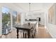 Bright dining area with access to the outdoor patio, an elegant wooden table and an open layout to the modern kitchen at 11989 E Lake Cir, Greenwood Village, CO 80111