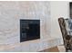 Close-up of a modern fireplace featuring marble surround and hearth at 11989 E Lake Cir, Greenwood Village, CO 80111