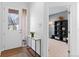 Inviting foyer with hardwood floors and a view into a well-lit room at 11989 E Lake Cir, Greenwood Village, CO 80111