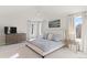 Bright main bedroom featuring a ceiling fan, ample natural light, and stylish decor, creating a relaxing retreat at 11989 E Lake Cir, Greenwood Village, CO 80111