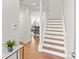 Bright staircase with wood treads and white risers, leading to a living space with ample natural light at 11989 E Lake Cir, Greenwood Village, CO 80111