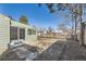 Backyard features a partially covered patio, fence, and mature trees at 2660 S King St, Denver, CO 80219