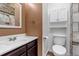 Modern half-bathroom featuring a stylish vanity with a stone backsplash and a toilet at 4194 S Fraser Way # B, Aurora, CO 80014
