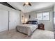 Comfortable bedroom featuring a queen bed, closet, and a side table at 4194 S Fraser Way # B, Aurora, CO 80014