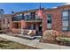 Exterior view of brick condo units with balconies and patios, showcasing outdoor living spaces at 4194 S Fraser Way # B, Aurora, CO 80014
