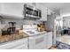 Well-equipped kitchen with white cabinets, stainless steel appliances, granite countertops, and a cozy breakfast nook nearby at 4194 S Fraser Way # B, Aurora, CO 80014