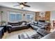 Spacious living room with a brick fireplace that adds character and warmth to the space with lots of natural light at 4194 S Fraser Way # B, Aurora, CO 80014