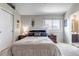 Cozy bedroom featuring neutral walls, a large window for natural light, and access to an ensuite bathroom for added convenience at 4194 S Fraser Way # B, Aurora, CO 80014