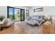 Bright bedroom with balcony access offering picturesque forest views, and a cozy seating area at 13415 S Resort Dr, Conifer, CO 80433