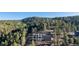 Scenic view of modern mountain home nestled among towering trees on a gently sloping hillside at 13415 S Resort Dr, Conifer, CO 80433