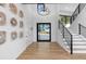 Inviting foyer with modern chandelier, wood accents, and staircase leading to the upper level at 13415 S Resort Dr, Conifer, CO 80433