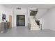 Inviting foyer featuring a modern staircase, stylish console table, and ample natural light at 13415 S Resort Dr, Conifer, CO 80433