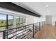Hallway overlooking living space, showcases large windows with scenic views and stone accent wall with fireplace at 13415 S Resort Dr, Conifer, CO 80433