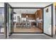 Modern kitchen with wood cabinets, marble countertops, and an island, seen through open doors at 13415 S Resort Dr, Conifer, CO 80433