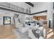Bright, open-concept living room featuring modern furnishings, hardwood floors, and views of the gourmet kitchen at 13415 S Resort Dr, Conifer, CO 80433