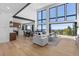 Bright, open-concept living room flowing into the kitchen, featuring floor-to-ceiling windows with mountain views at 13415 S Resort Dr, Conifer, CO 80433