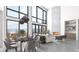 Bright living room featuring a stone fireplace, soaring ceilings, and large windows with scenic views at 13415 S Resort Dr, Conifer, CO 80433