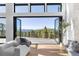 Living room featuring mountain views and deck access through retractable doors, with a modern chair at 13415 S Resort Dr, Conifer, CO 80433