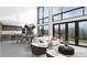 Open-concept living room with large windows, seamlessly connecting to the kitchen and dining area at 13415 S Resort Dr, Conifer, CO 80433