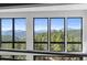 Multiple large windows offering stunning panoramic views of the surrounding mountain and forest landscape at 13415 S Resort Dr, Conifer, CO 80433