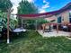 A back yard with a cozy hammock and covered patio is a perfect place to relax outdoors at 247 N Coolidge Way, Aurora, CO 80018