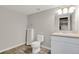 Clean, neutral bathroom with a modern sink and a separate toilet and urinal at 247 N Coolidge Way, Aurora, CO 80018