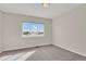 Cozy bedroom featuring a large window with a view, carpeted floors, and ample natural light at 247 N Coolidge Way, Aurora, CO 80018