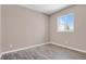 Cozy bedroom with hardwood floors, neutral paint, and a bright window view at 247 N Coolidge Way, Aurora, CO 80018