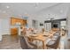 Open-concept dining area featuring wood floors, stylish furniture, and seamless integration with the kitchen, creating an inviting space at 247 N Coolidge Way, Aurora, CO 80018