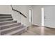 Bright entryway with hardwood floors and staircase, leading to an upstairs hallway at 247 N Coolidge Way, Aurora, CO 80018