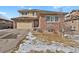 Charming two-story home features a brick and siding exterior, attached garage, and a well-maintained front yard at 247 N Coolidge Way, Aurora, CO 80018