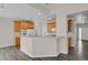 Open-concept kitchen with wood cabinetry, bar-top seating, and modern appliances at 247 N Coolidge Way, Aurora, CO 80018