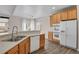 Bright kitchen area featuring ample counter space, modern appliances, and natural light at 247 N Coolidge Way, Aurora, CO 80018