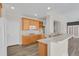 Bright kitchen with wood cabinets, white countertops, and a breakfast bar overlooking the living area at 247 N Coolidge Way, Aurora, CO 80018