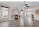 Bright and airy living room with hardwood floors, a fireplace, and an open layout at 247 N Coolidge Way, Aurora, CO 80018