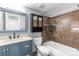 Bathroom with blue vanity, tiled walls, and decorative mirror at 6861 Xavier Cir # 3, Westminster, CO 80030