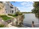 Exterior view of lakeside condo with stone facade, manicured lawn, and lake access at 6861 Xavier Cir # 3, Westminster, CO 80030