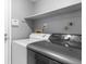 Convenient laundry room featuring modern washer and dryer units and overhead shelving at 6861 Xavier Cir # 3, Westminster, CO 80030