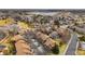 High-angle aerial shot of townhomes in a neighborhood with mature trees and a nearby lake at 2263 E 129Th Ave, Thornton, CO 80241