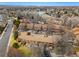 Aerial of townhomes in community with tree lined streets and lake at 2263 E 129Th Ave, Thornton, CO 80241