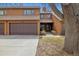 Charming townhome exterior with a two-car garage, well-manicured lawn, and inviting entrance at 2263 E 129Th Ave, Thornton, CO 80241