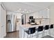 Updated kitchen featuring a breakfast bar, stainless appliances, and white cabinetry at 2263 E 129Th Ave, Thornton, CO 80241