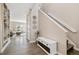 Open-concept living room with wood floors, stairs, decorative bench, and light-filled windows at 2263 E 129Th Ave, Thornton, CO 80241